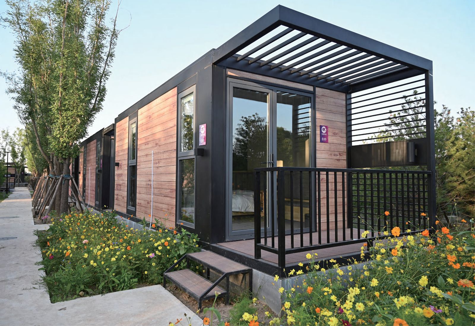 Modern prefab villa exterior in landscaped setting